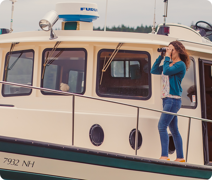 miramonee harrington on boat with binoculars